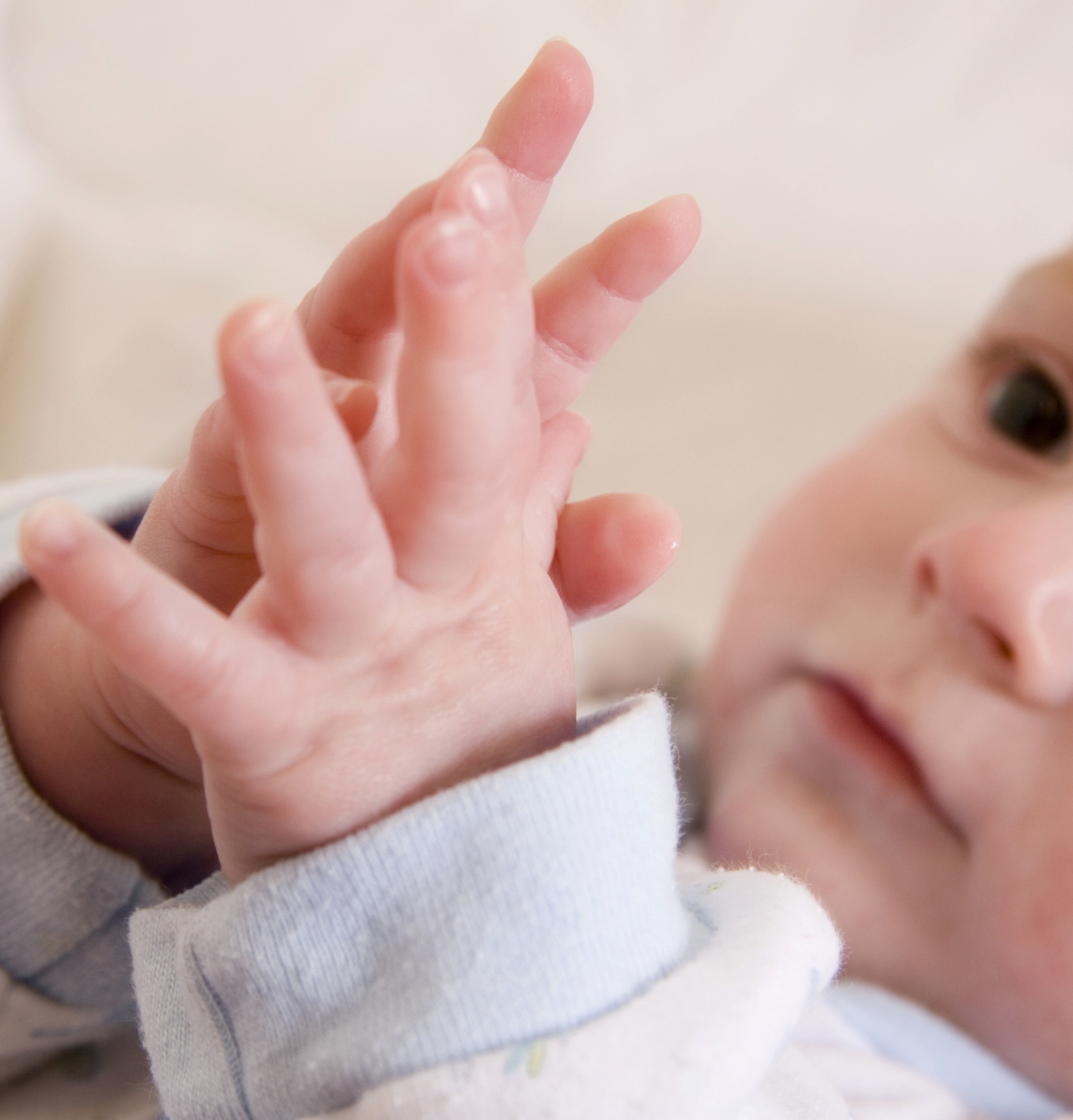 Baby touching fingertips